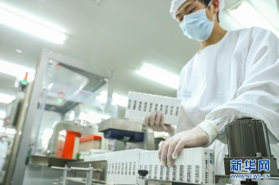 工作人员在国药集团中国生物北京生物制品研究所的新冠病毒灭活疫苗分包装车间内工作 ...