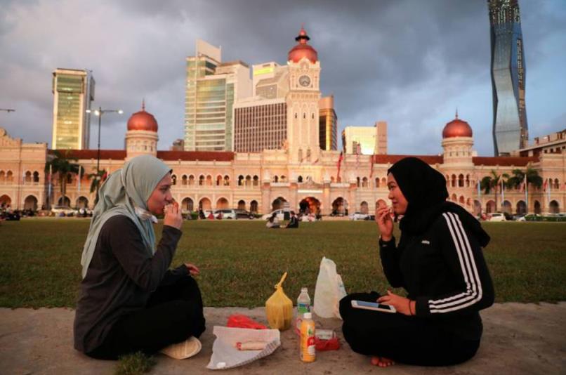 大马首都吉隆坡2名穆斯林结束当日斋戒后，脱口罩饮食